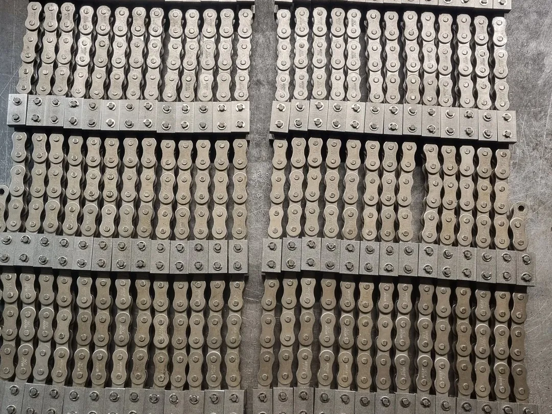 Cut lengths of attachment chain assembled and laid out on the workshop bench