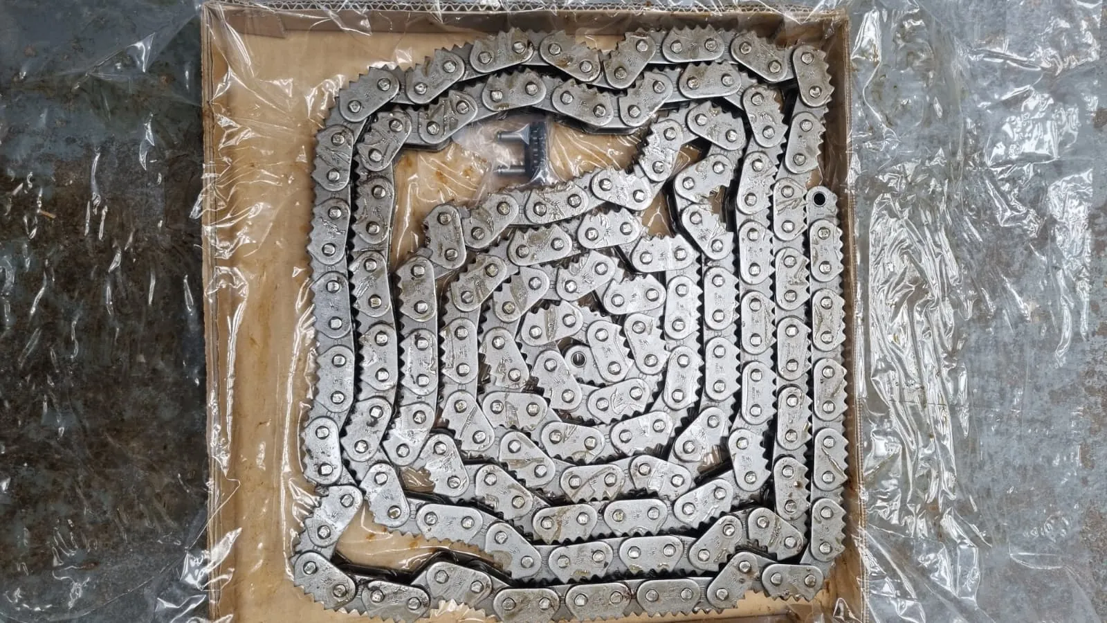 Fine-pitch sharp top chain coiled in a stock crate